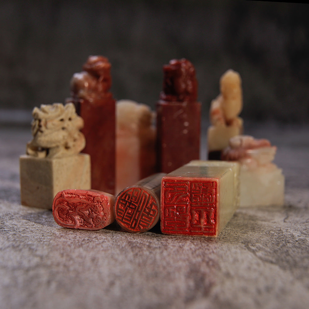 Oriental Seal Stone Chop Assortment with chops being visible from the bottom showing the red ink on the custom-carved base