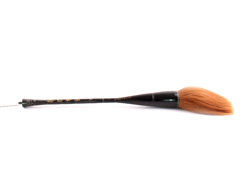 Horizontal full view of extra large Chinese calligraphy paiting / calligraphy brush made by hand with a black buffalo horn handle and orange horse hair