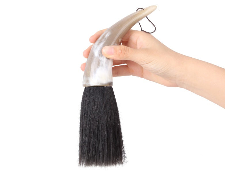 usage view of the mongolian steppe bull horn brush whose tip is made of black goat hair