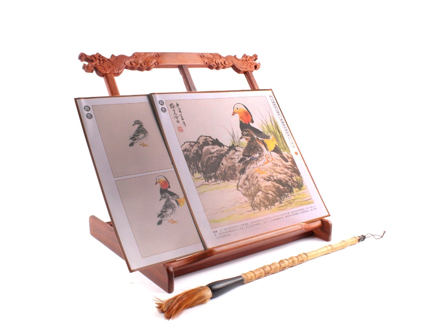 Traditional Chinese learning material stand with hand-carvings of dragon heads as decorative items; usage picture showing how sumi painting books or calligraphy books can be positioned on the stand while painting or writing