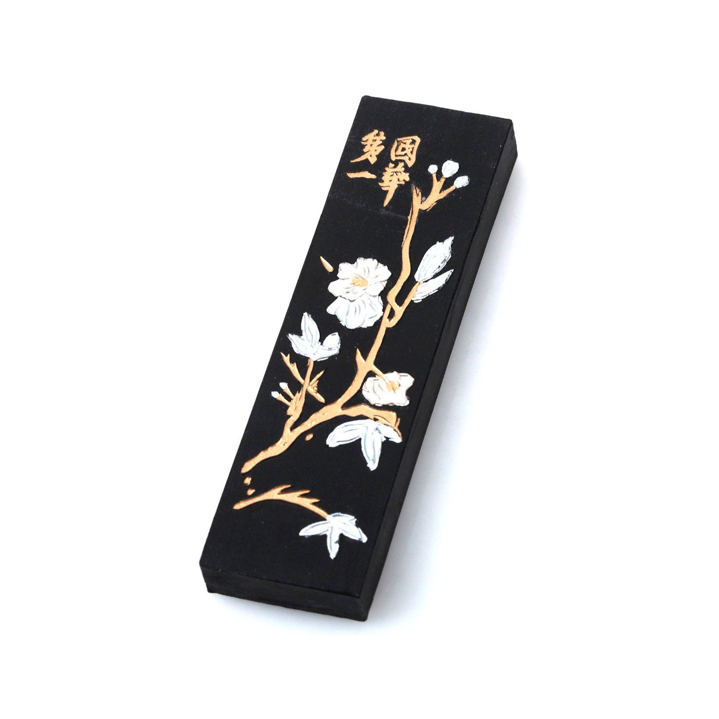Black Japanes / Chinese ink stick for sumi and calligraphy, nicely decorated with white plum tree blossoms on golden branches and golden decorative Chinese lettering.