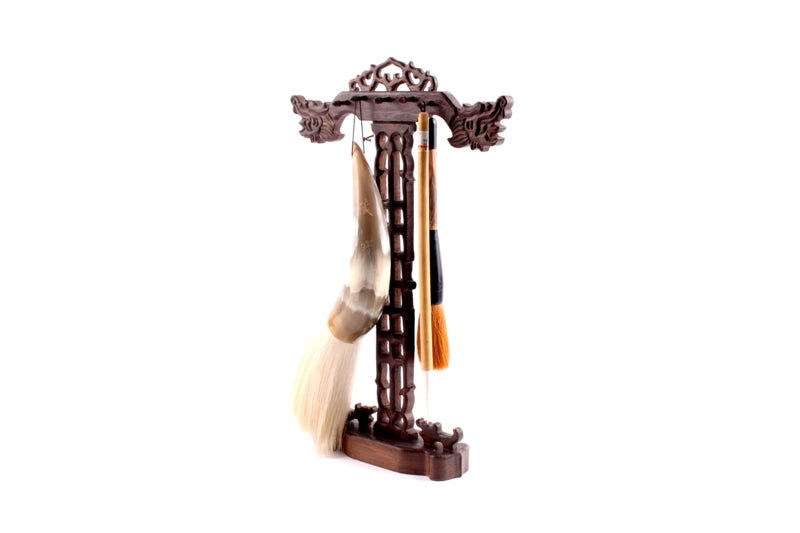 Decorative Oriental brush hanger with Chinese dragon head carvings and brushes attached to the rack to display the usage