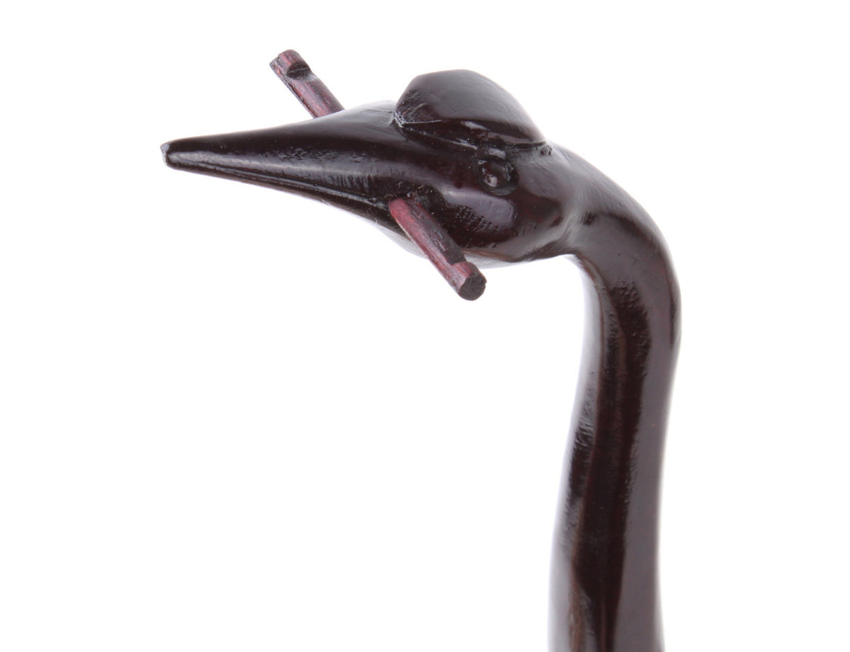 a brush hanger that is handmade into the shape of an elegant crane which is a nice decorative item for your study room