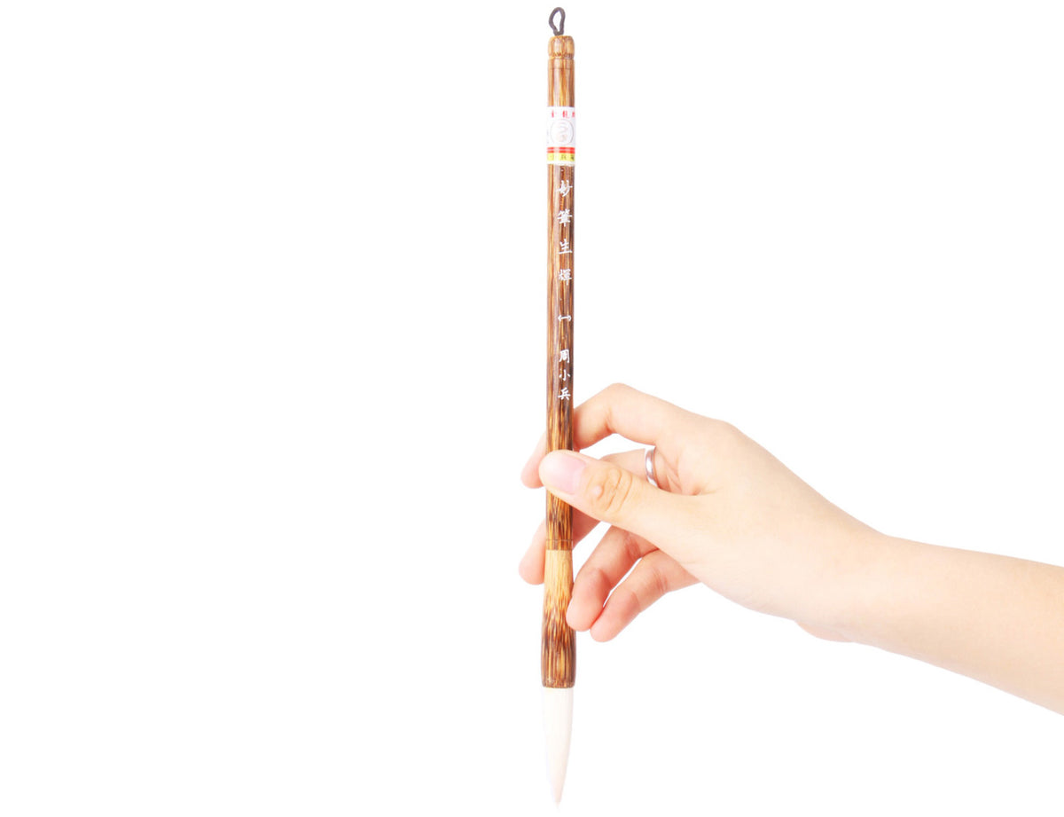 holding this brush just a little bit above the brush tip to practice sumi painting and calligraphy writing