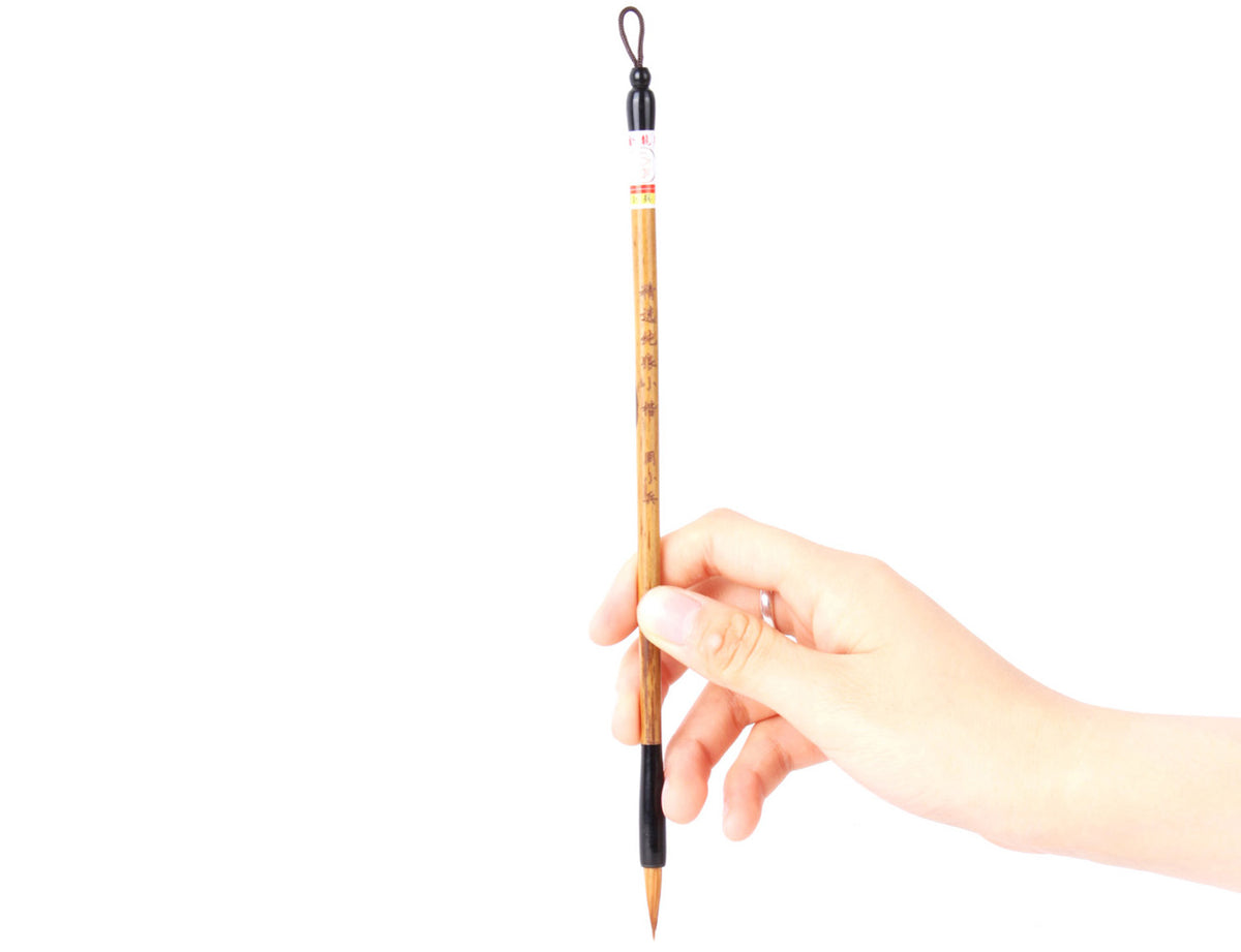 usage view of this premium wolf hair brush with your hand holding at about two fifths of its handle