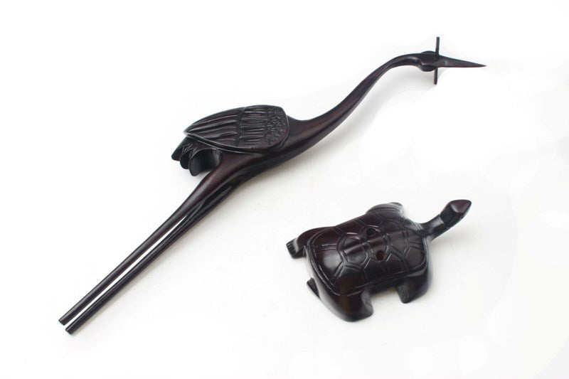 usage view of the elegant crane brush hanger with   a weasel brush which is mainly used for writing   calligraphy and painting lines in sumi