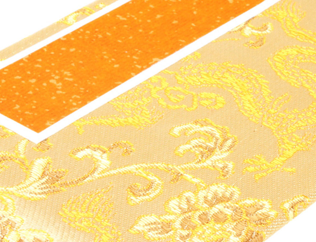 detail view of the brocade dragon on the silk of the album cover