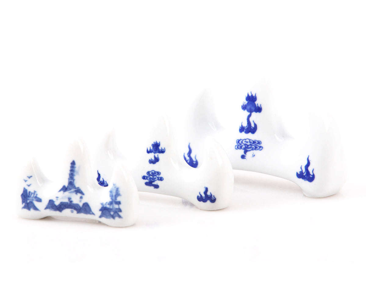 Assortment of three different sizes of the Flaming Mountain Oriental brush rest hand crafted from white porcelain and hand painted with blue ornaments shaped like flames - fits 3 brushes with thin handle