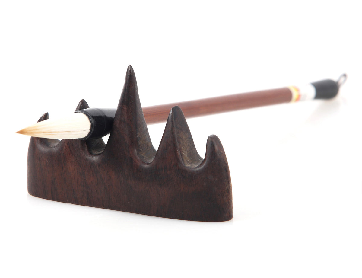 usage view of the moving the mountain brush rest indicating how you can use it to rest your calligraphy and sumi brushes