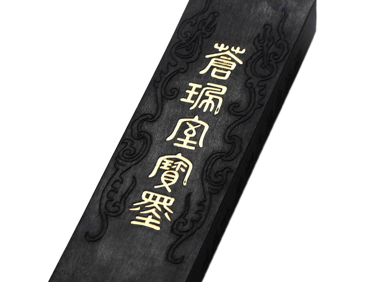 Zoom detail view of the decorative items on a premium quality Chinese / Japanese sumi and calligraphy ink stick