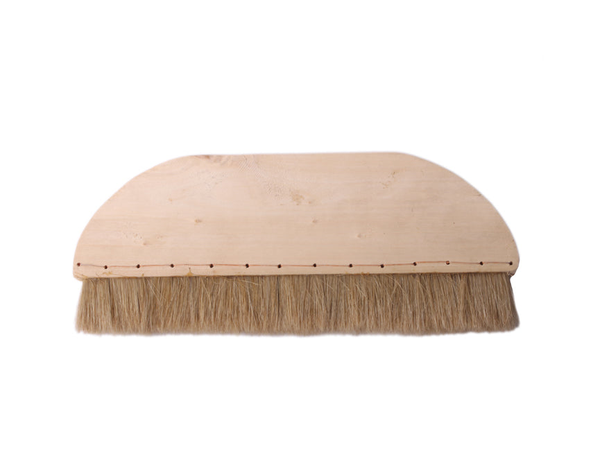 Full-zoom close up view on the firm and resilient swine hair bristles forming the tip of a extra wide mounting hard brush used in the process of wet mounting sumi paintings and calligraphy artworks 