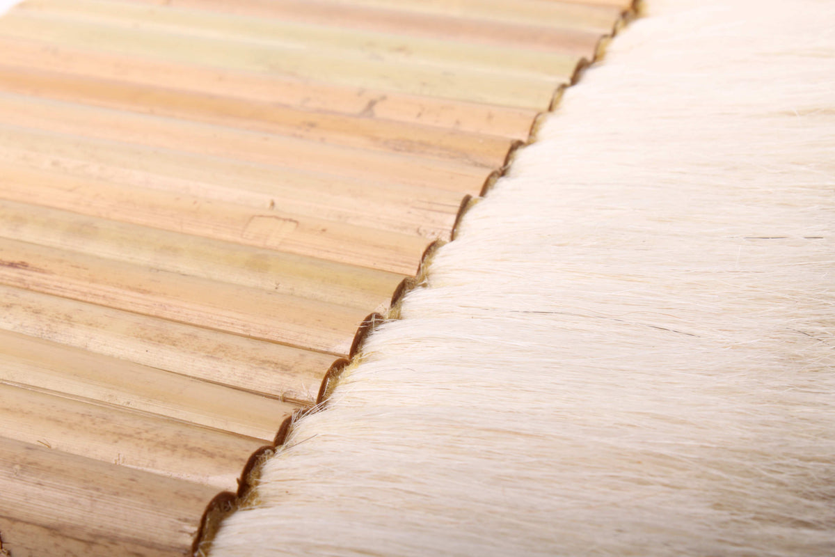 Detail close-up view of the white goat bristles of soft goat hair of a typical wet mounting brush used in Chinese and Japanese sumi painting and calligraphy with yello bamboo tubes as handle