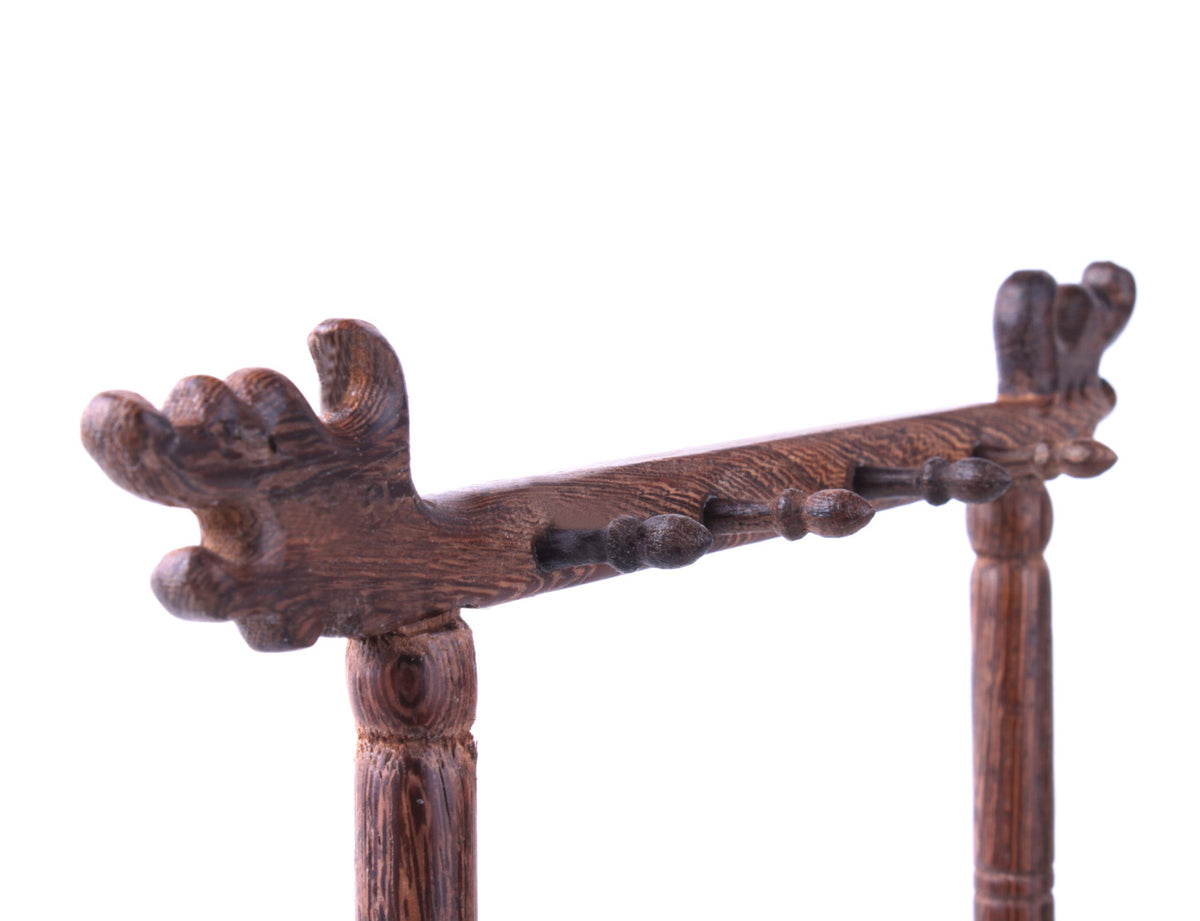 detail view of the head of this brush hanger with all the small hangers pointing out to hang up your brushes