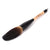 Thick tip dark goat hair bristles Chinese calligraphy and sumi brush lying flat on a surface and seen from the side. This brush has a hand-carved water buffalo and wooden handle and has similar characteristics as a more expensive bear hair brush.