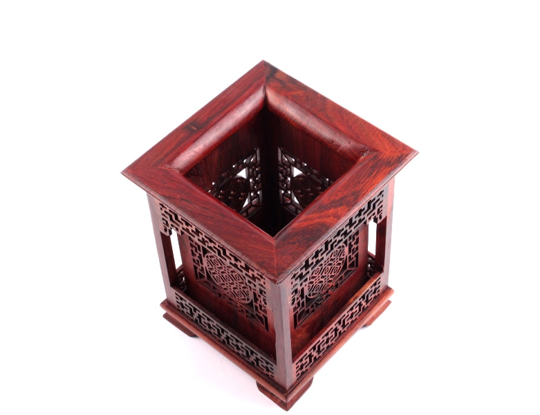 Top view of a meticulously hand carved wooden Chinese brush holder with relief-carving patterns of Chinese patterns used to store shodo and sumi brushes.