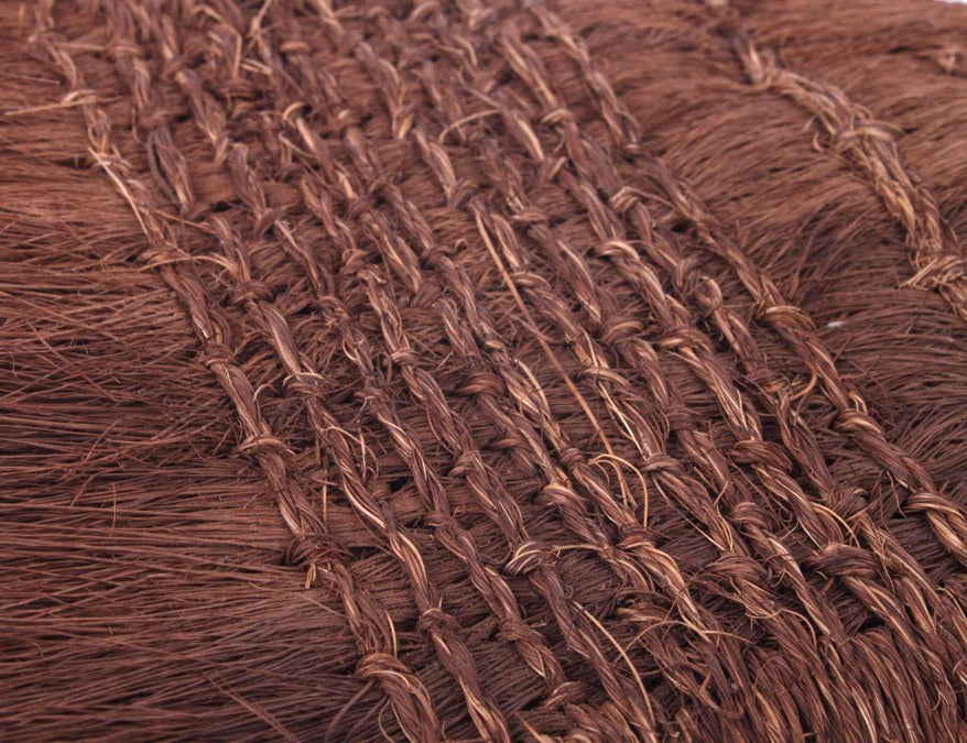 Close up zoom view of the weaving technique applied to this dark palm fibre hard brush used in the process of wet mounting an Oriental painting on a backing rice paper