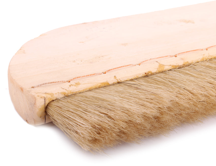 Full-zoom close up view on the firm and resilient swine hair bristles forming the tip of a extra wide mounting hard brush used in the process of wet mounting sumi paintings and calligraphy artworks 