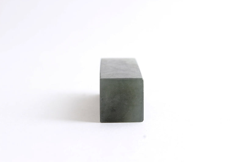 Kanji calligraphy artwork signature sealstone in natural dark green color.